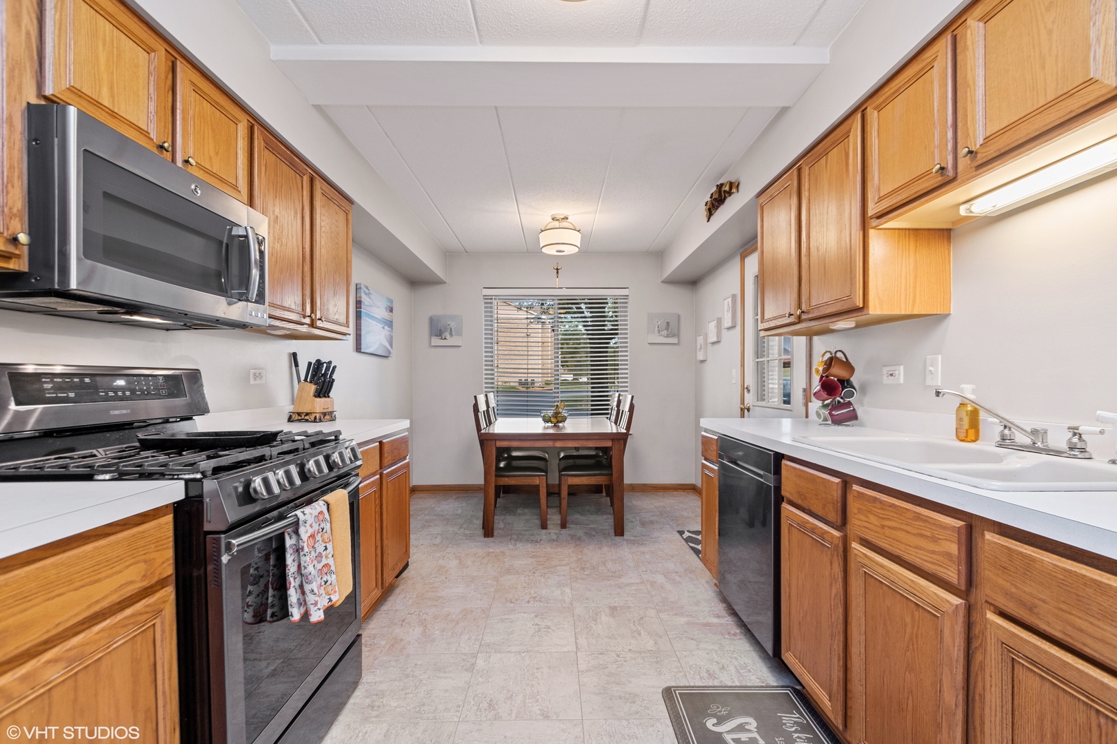 6850 Ridge Point Drive, Unit 1A Oak Forest, IL 60452 - Photo 10 of 20 a kitchen with stainless steel appliances a stove a sink dishwasher and cabinets with wooden floor