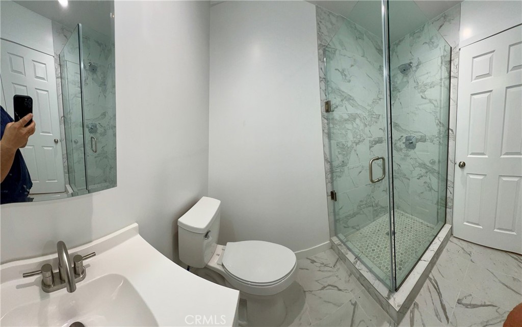 18654 1/2 Runnymede Street Reseda, CA 91335 - Photo 5 of 12 a bathroom with a toilet and a sink