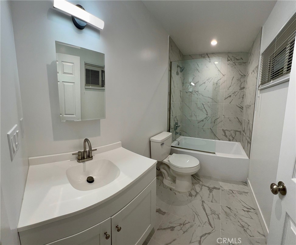 18654 1/2 Runnymede Street Reseda, CA 91335 - Photo 8 of 12 a bathroom with a sink toilet and shower