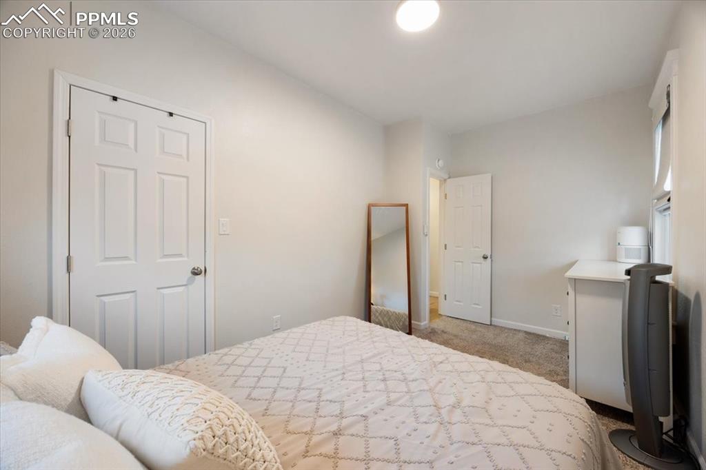 421 South Prospect Street Colorado Springs, CO 80903 - Photo 12 of 48 a bedroom with a bed and a flat tv screen