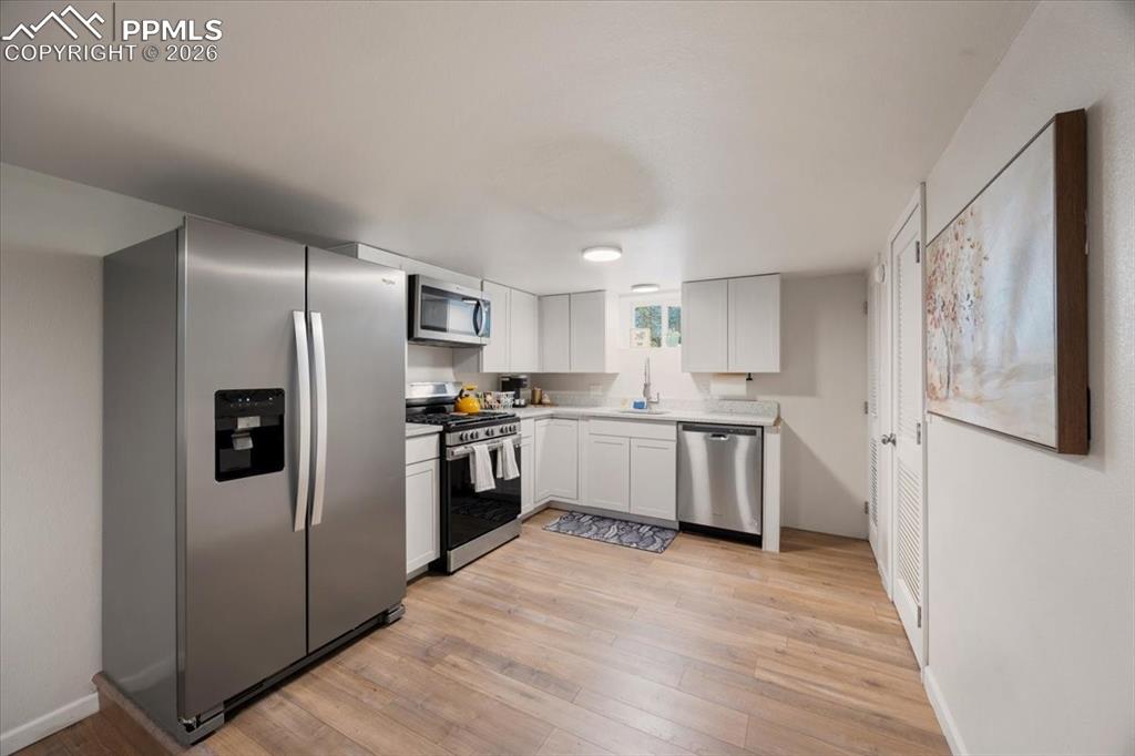 421 South Prospect Street Colorado Springs, CO 80903 - Photo 22 of 48 a kitchen with a refrigerator sink and cabinets