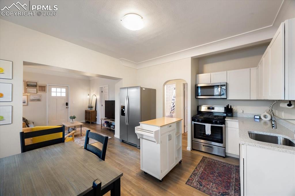 421 South Prospect Street Colorado Springs, CO 80903 - Photo 8 of 48 a large white kitchen with stainless steel appliances