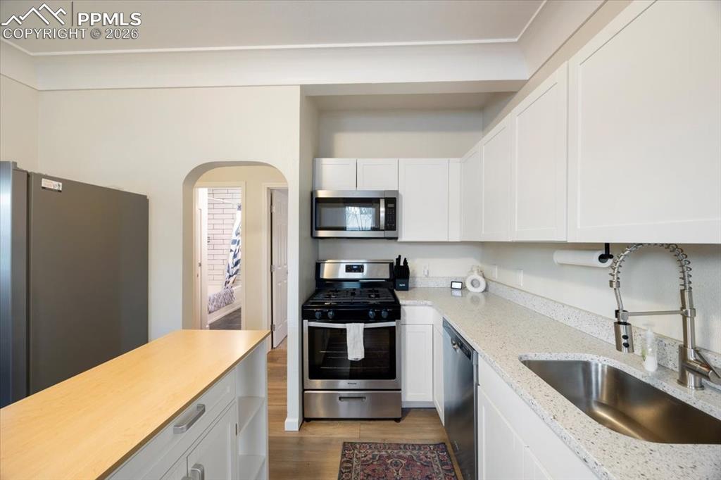 421 South Prospect Street Colorado Springs, CO 80903 - Photo 9 of 48 a kitchen with a sink and refrigerator