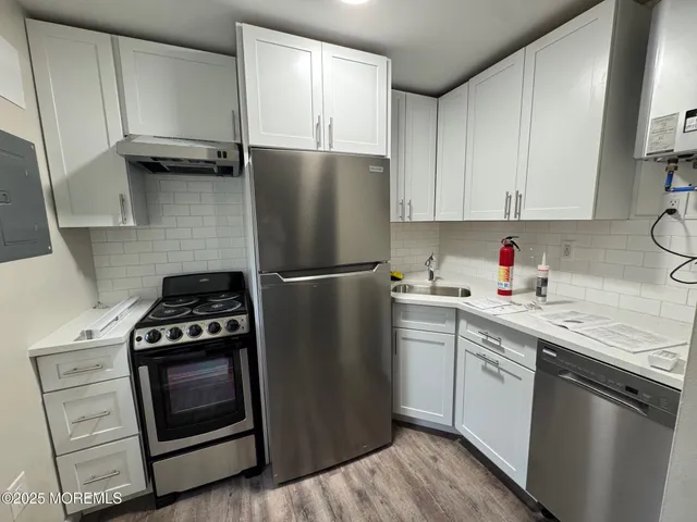 a kitchen with a stove microwave and a refrigerator