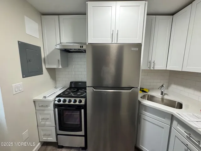 a kitchen with a refrigerator and a stove