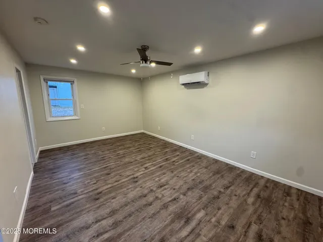 an empty room with a empty space and wooden floor