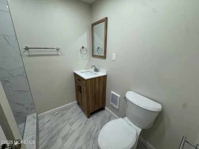 a white toilet sitting next to a bathroom sink