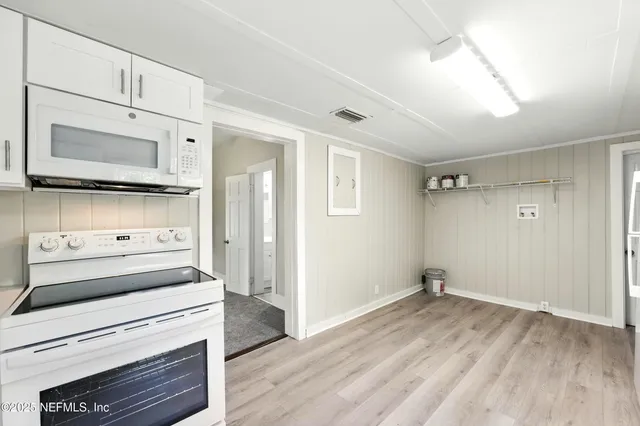 a kitchen with a stove and a microwave