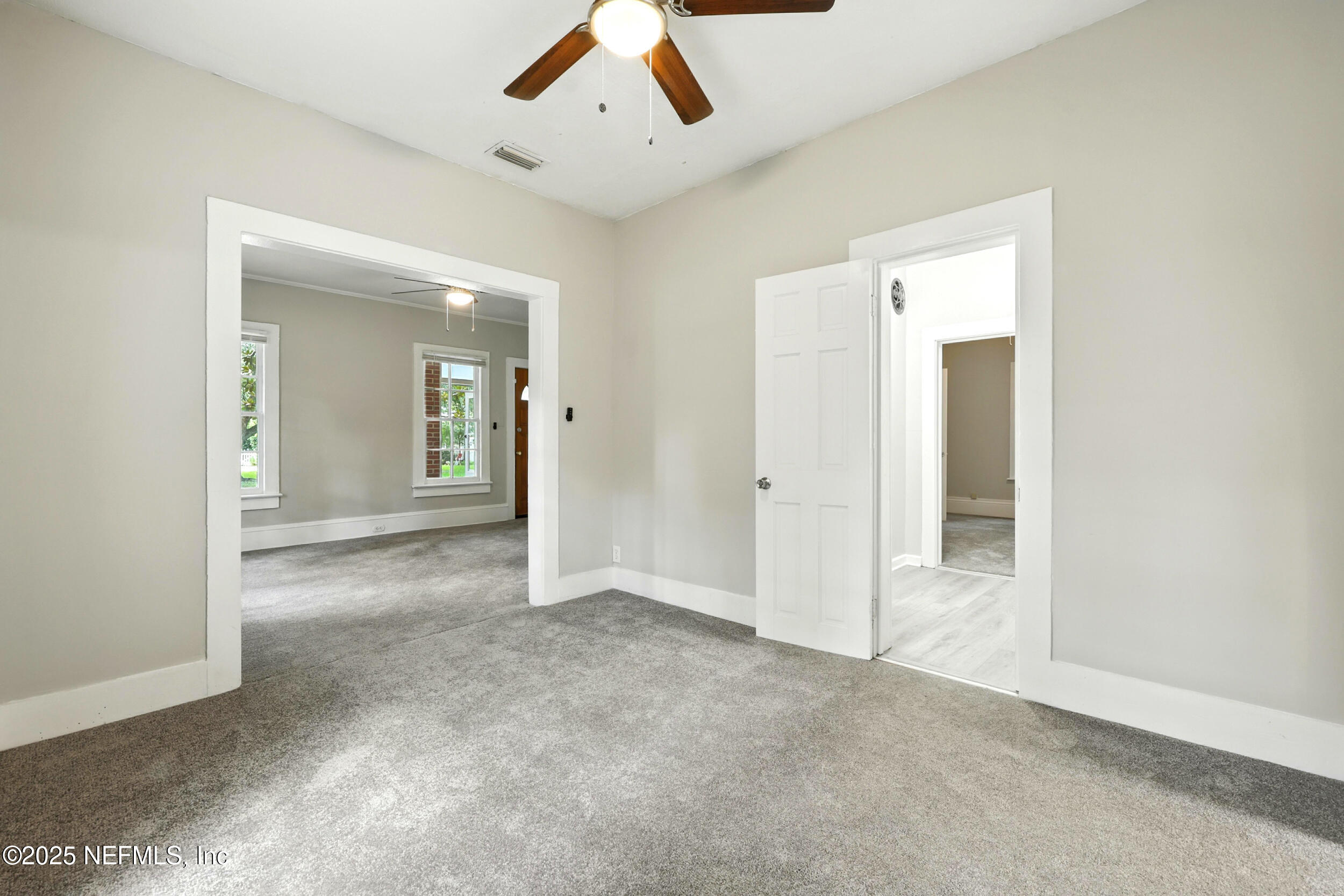 2858 Downing Street Jacksonville, FL 32205 - Photo 14 of 29 an empty room with fan and a hallway