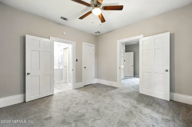 a view of empty room with ceiling fan