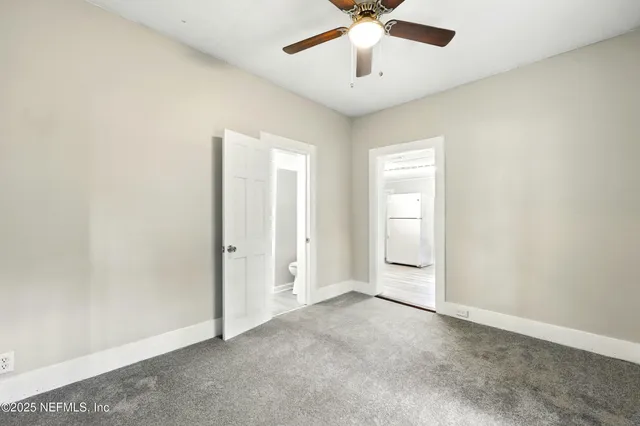 an empty room with a empty space and a ceiling fan