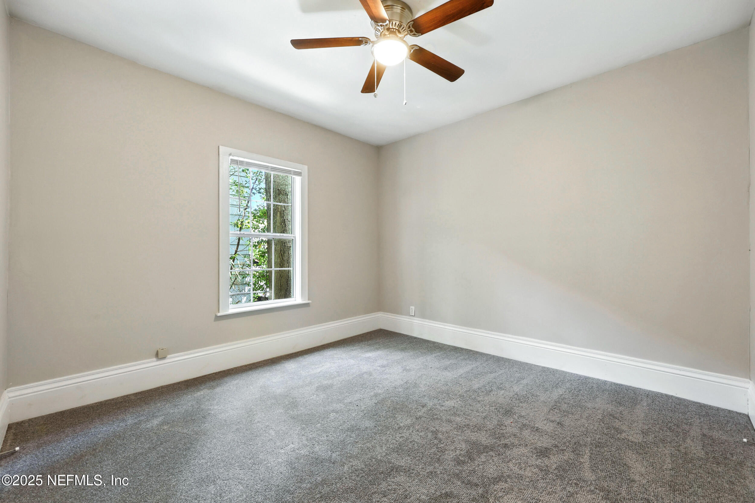 2858 Downing Street Jacksonville, FL 32205 - Photo 19 of 29 an empty room with a window and a fan