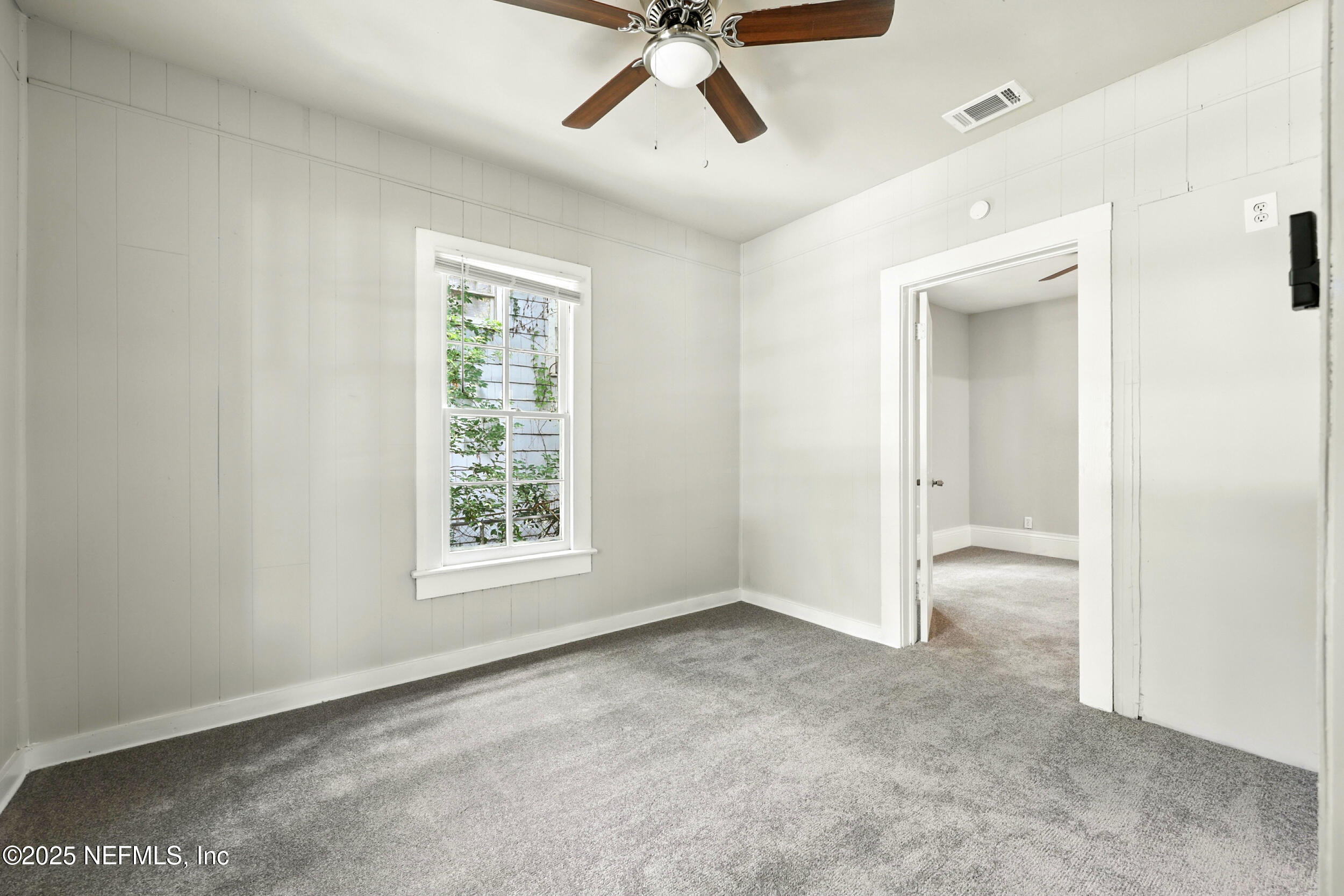 2858 Downing Street Jacksonville, FL 32205 - Photo 20 of 29 a view of a big room with windows and chandelier fan