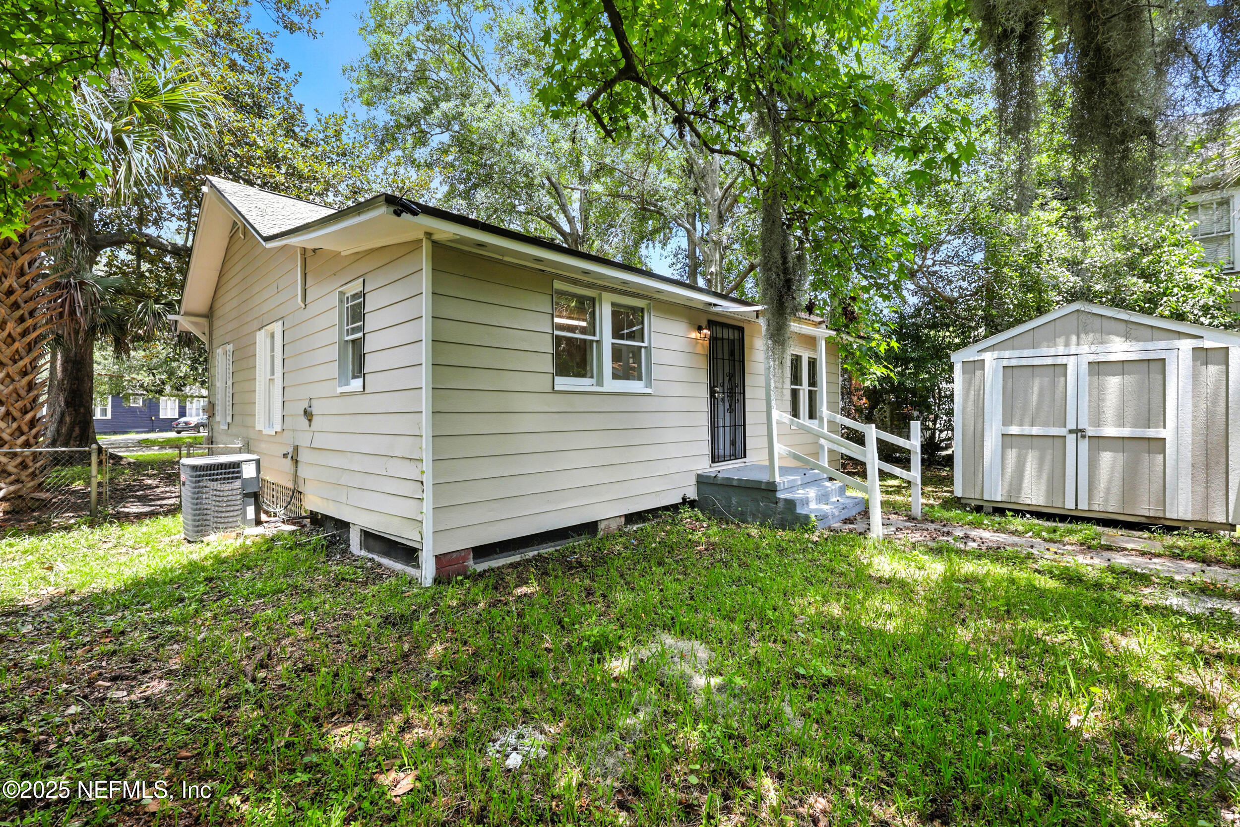 2858 Downing Street Jacksonville, FL 32205 - Photo 25 of 29 a backyard of a house with table and chairs a barbeque with wooden fence