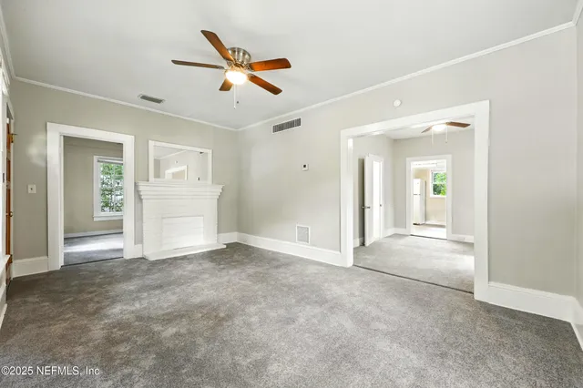 an empty room with closet and windows