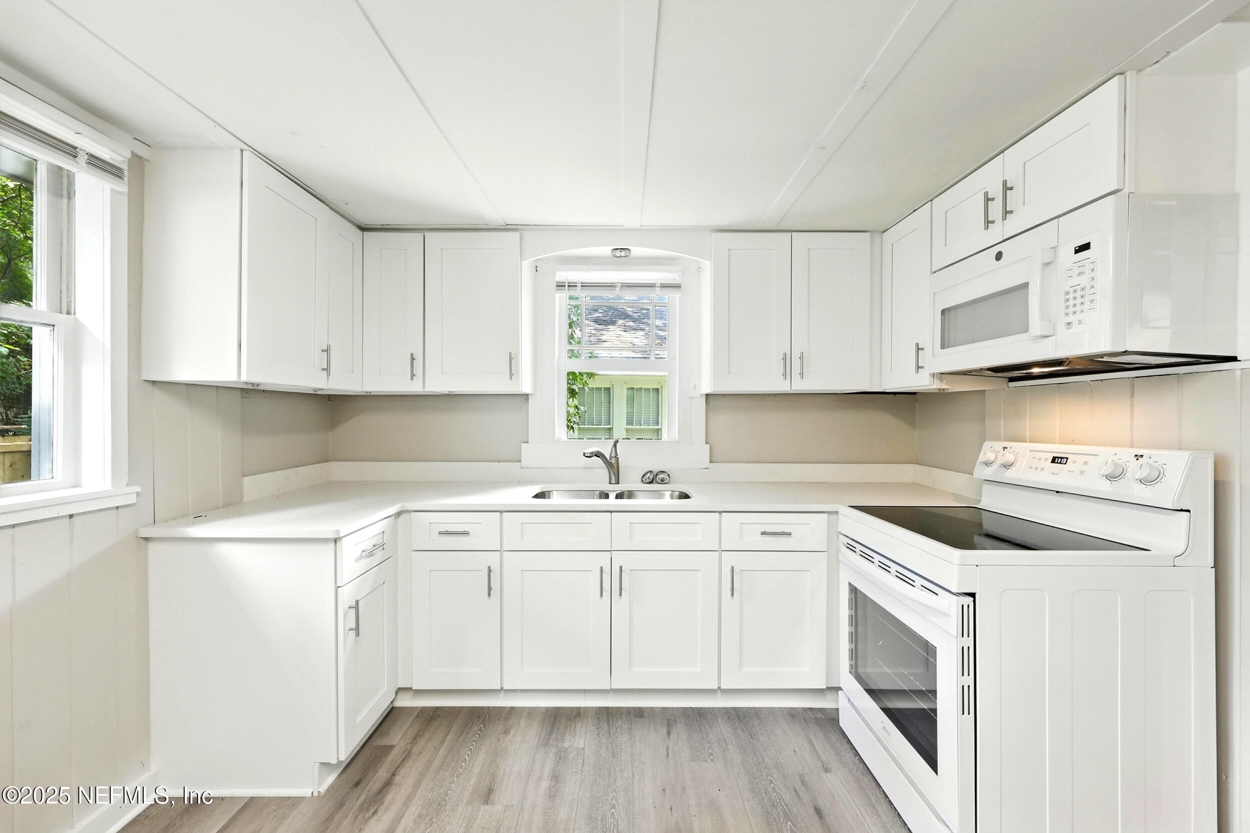 2858 Downing Street Jacksonville, FL 32205 - Photo 9 of 29 a view of a kitchen with cabinets appliances a sink and a window