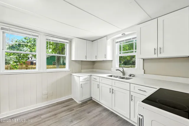 a kitchen with a sink stove and cabinets