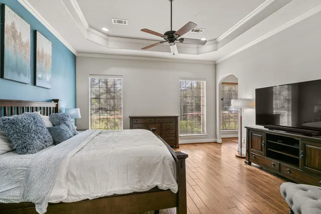 a bedroom with a bed and a flat screen tv