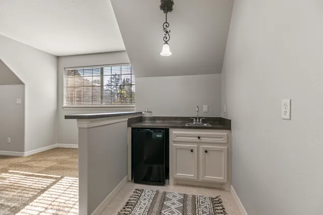 a kitchen with granite countertop a sink and a stove