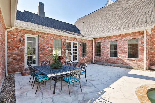 a view of a patio with a table and chairs