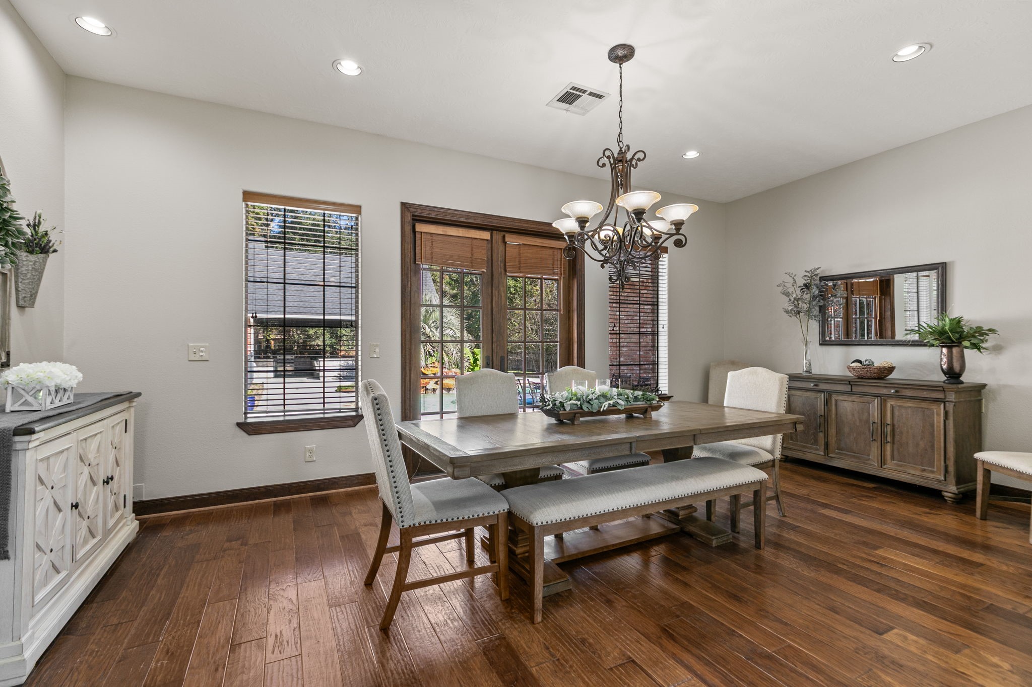 3811 Rayford Road Spring, TX 77386 - Photo 10 of 50 a dining room with wooden floor a chandelier a glass table and chairs