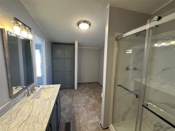 a bathroom with a tub shower and sink