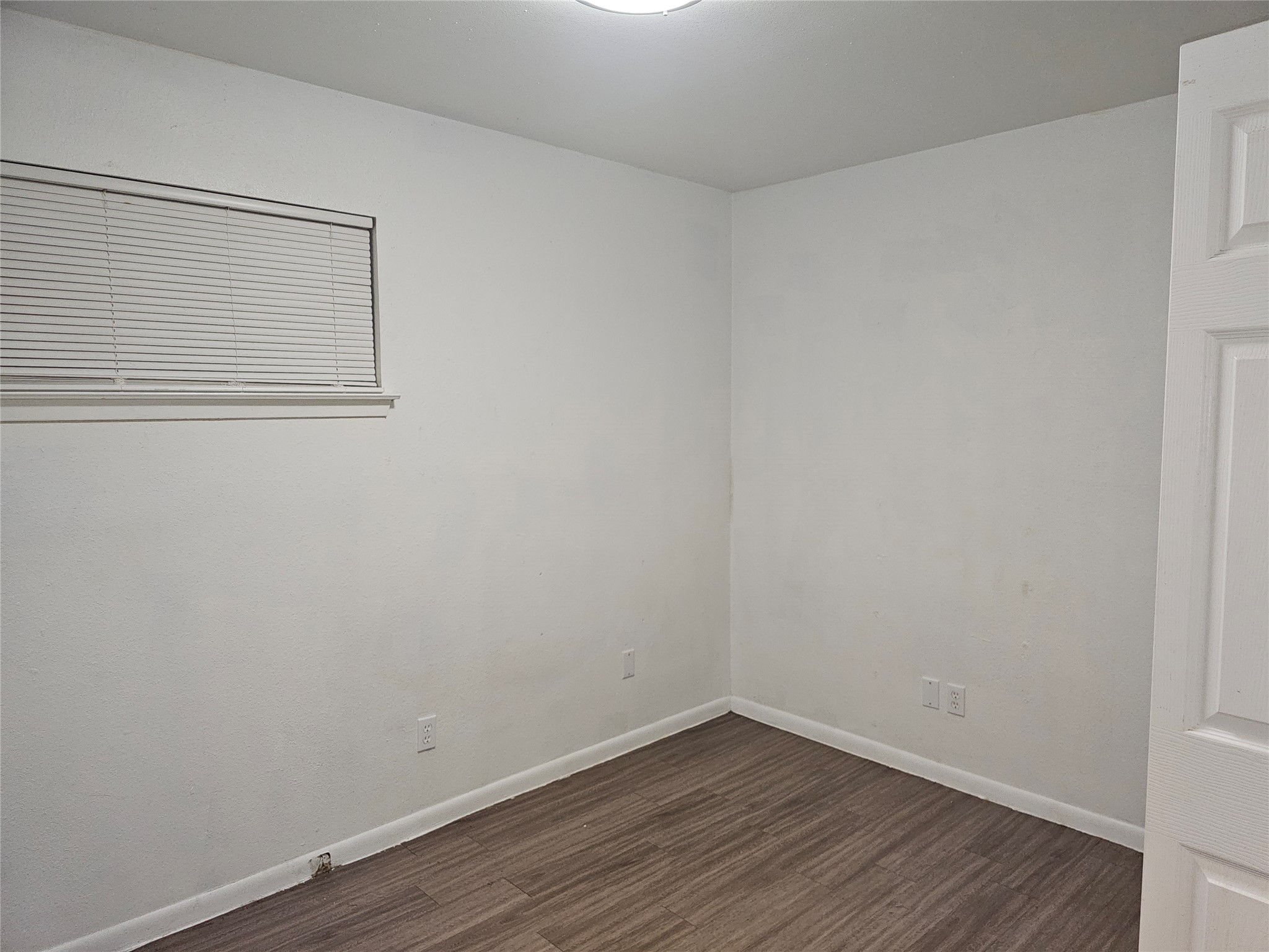 7300 Bennett Avenue, Unit B Austin, TX 78752 - Photo 11 of 11 a view of a small space with wooden floor and a window
