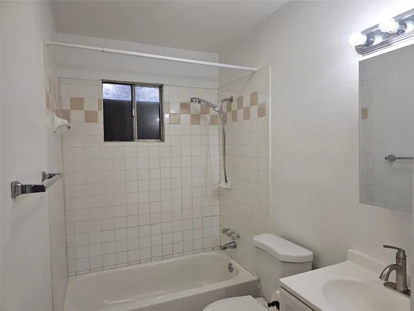 a bathroom with a toilet a sink and bathtub