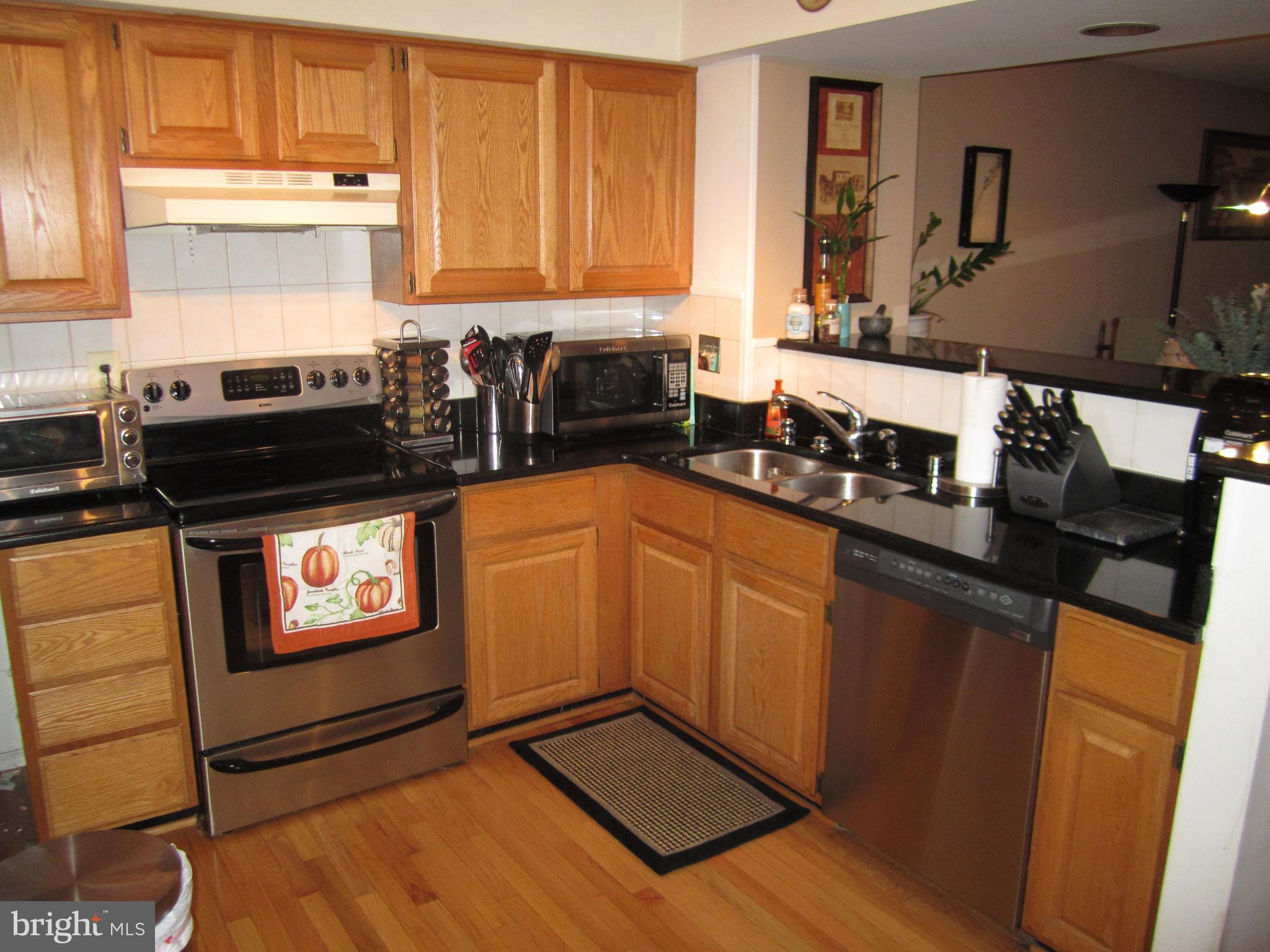 5010 9th Street South Arlington, VA 22204 - Photo 2 of 12 a kitchen with stainless steel appliances granite countertop a stove a sink and a microwave
