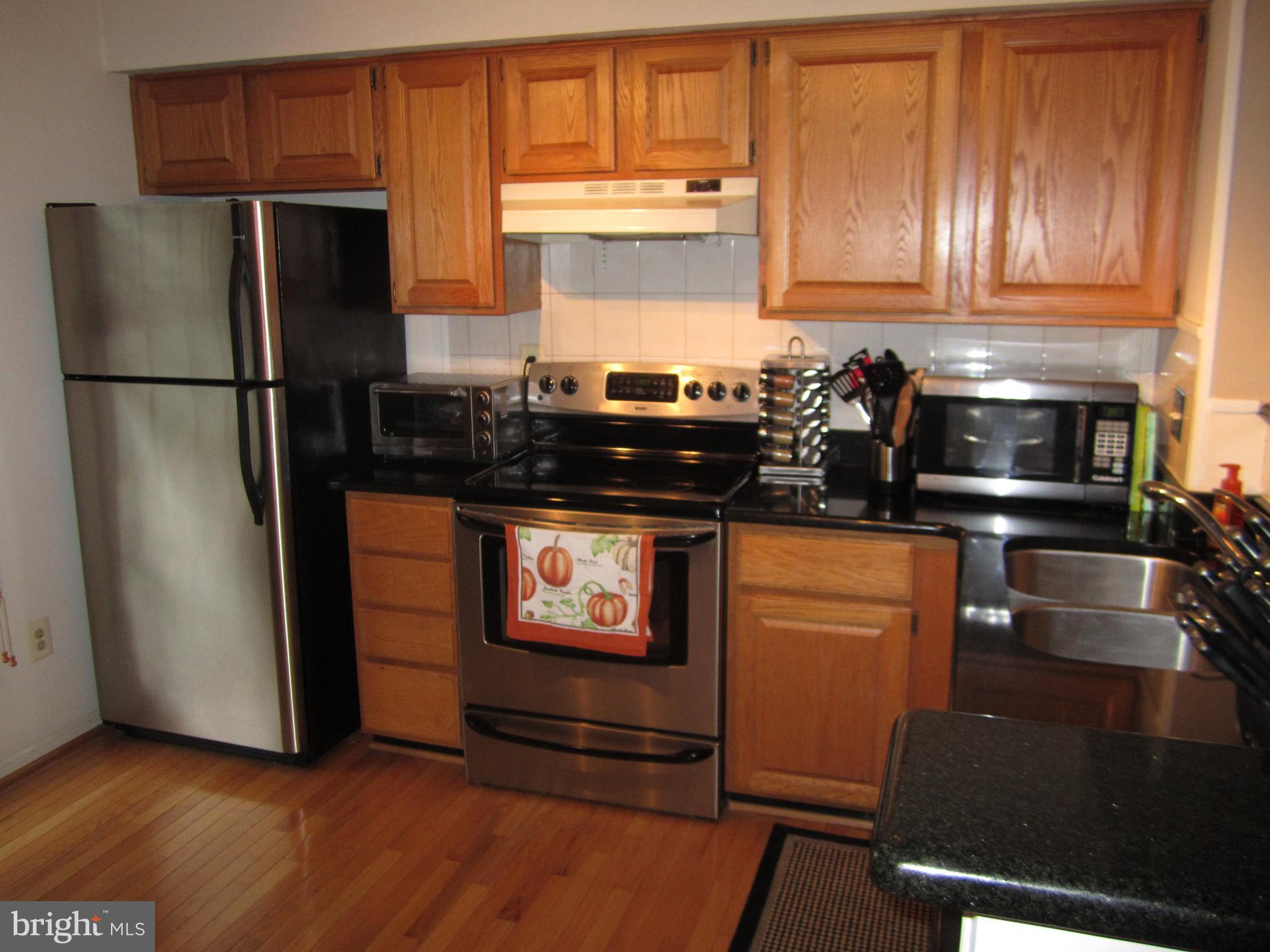 5010 9th Street South Arlington, VA 22204 - Photo 4 of 12 a kitchen with stainless steel appliances granite countertop a refrigerator and a stove top oven