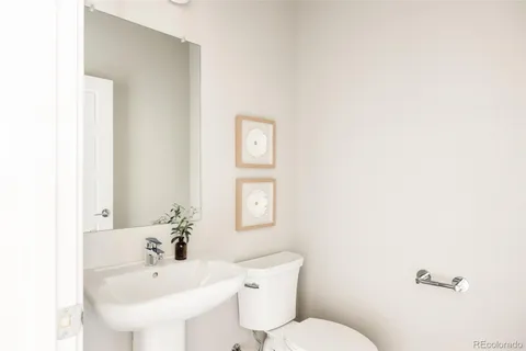 a bathroom with a sink mirror and toilet