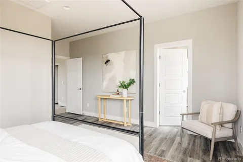 a bedroom with a bed and a chair