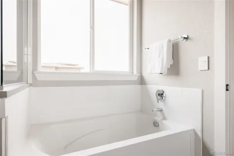 a white bath tub sitting next to a white sink