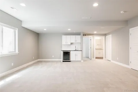 a view of empty room with a kitchen