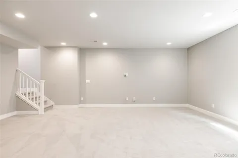 an empty room with windows and stairs