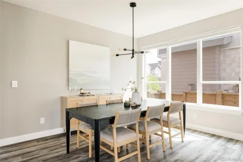 a view of a dining room with furniture window and wooden floor