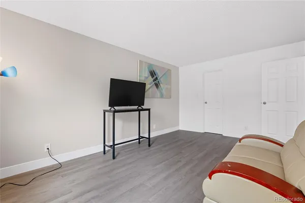 a room with wooden floor and white walls