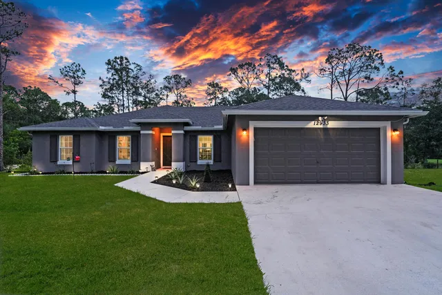 a front view of a house with garden and porch