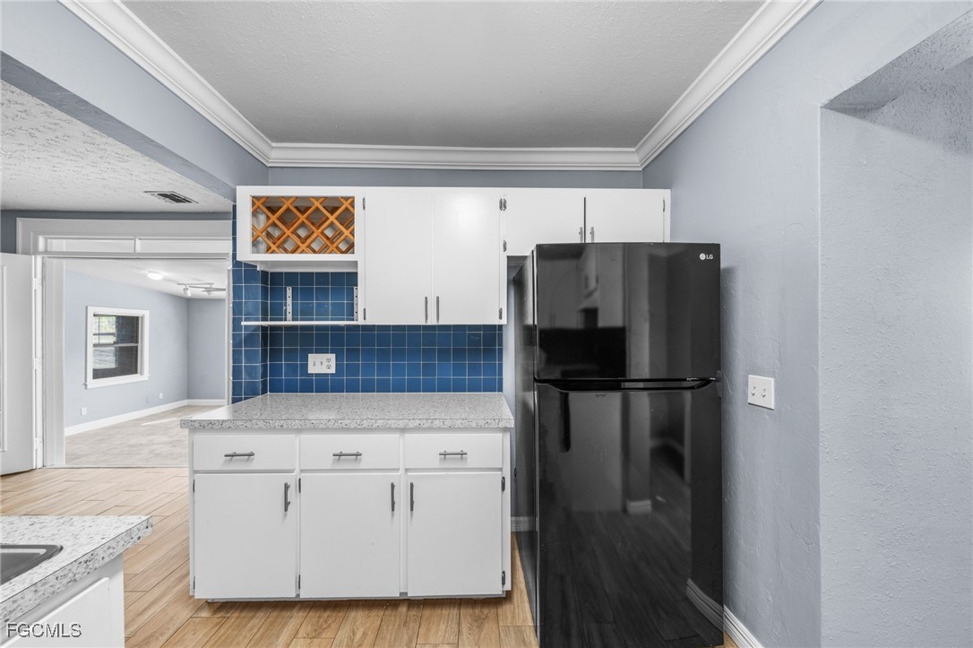 290 Granada Boulevard Fort Myers, FL 33905 - Photo 11 of 37 a kitchen with stainless steel appliances a refrigerator and a stove top oven