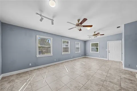 a view of a livingroom with a ceiling fan and window