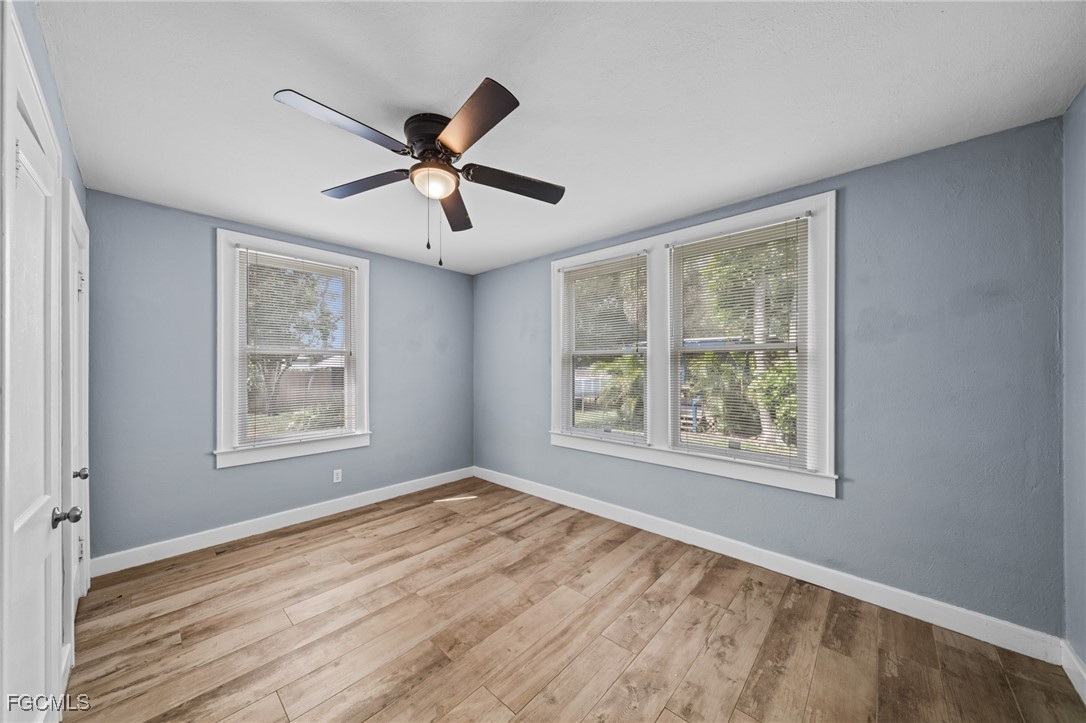 290 Granada Boulevard Fort Myers, FL 33905 - Photo 19 of 37 a view of an empty room with a window and wooden floor