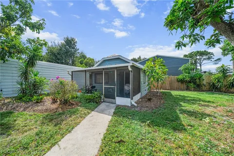 a view of a house with yard and a garden