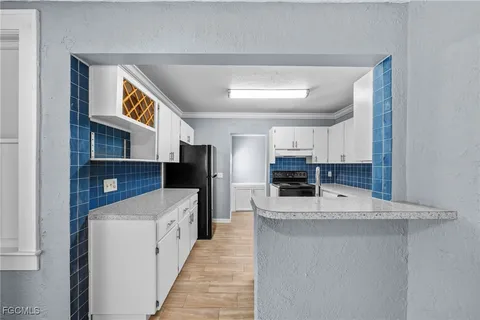 a kitchen with stainless steel appliances granite countertop a sink and a refrigerator