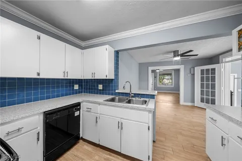 a kitchen with a sink cabinets and window