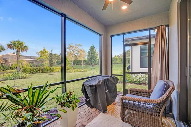 a view of an house with backyard and a tree