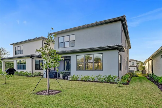 a large white kitchen with stainless steel appliances