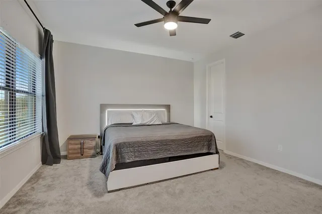 a view of a hallway with wooden floor and stairs