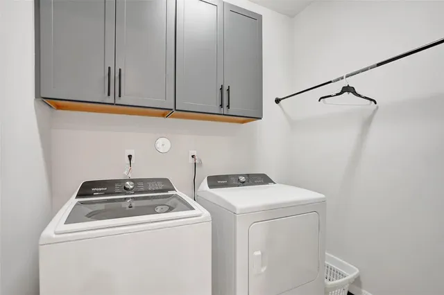 a kitchen with stainless steel appliances kitchen island granite countertop a dining table chairs and a refrigerator