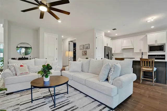 a living room with furniture and a floor to ceiling window
