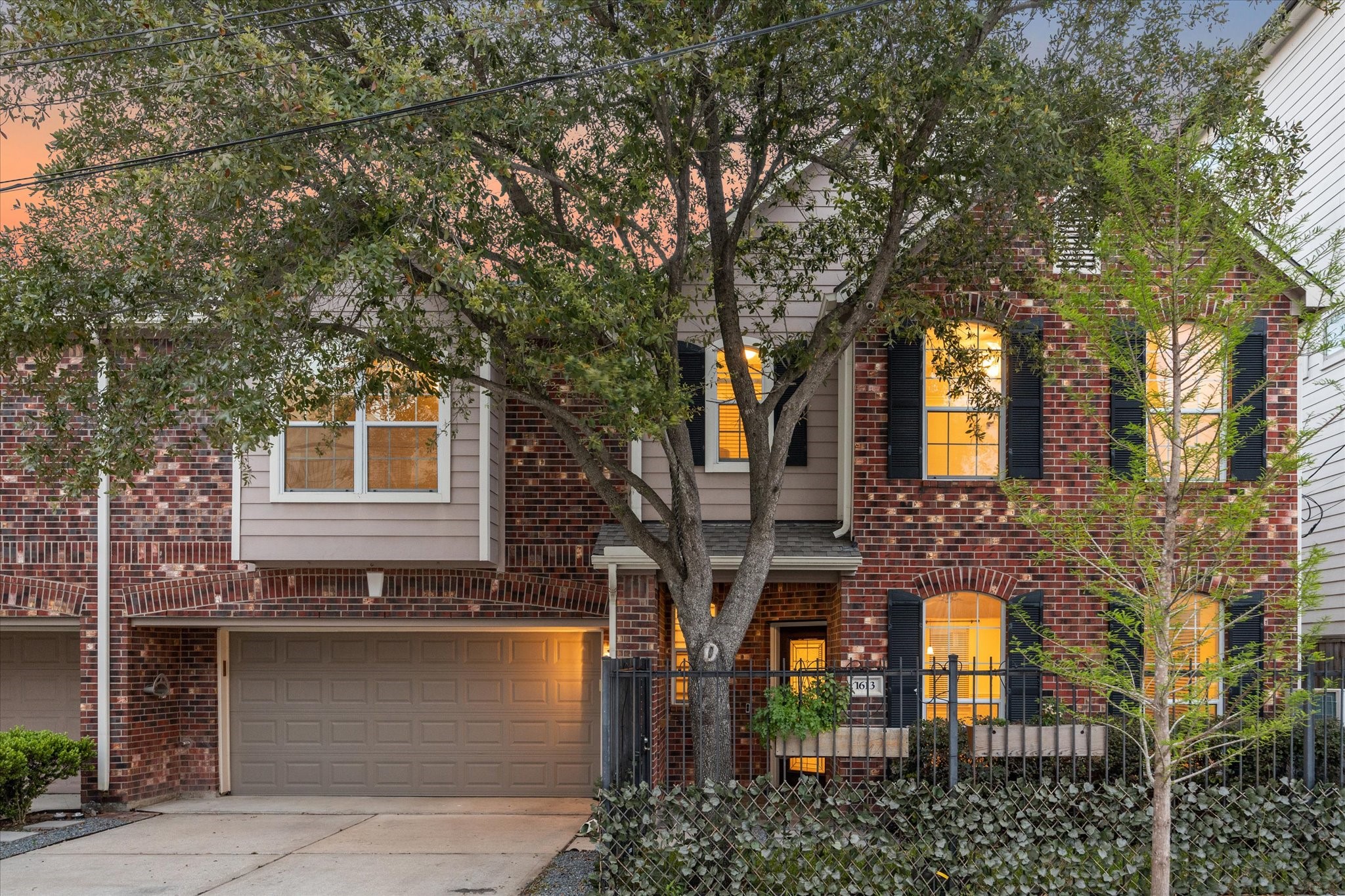 1613 West 15th Street Houston, TX 77008 - Photo 1 of 25 a front view of a house with glass windows and plants